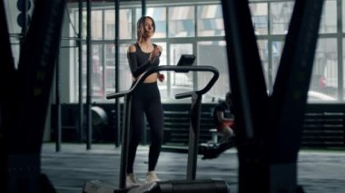 Woman athlete athlete is engaged in cardio training on the treadmill, thin sports girl