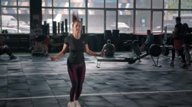 Young woman athlete trains cardio with jump rope, cardio training