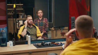 Barbershop: male client is very unhappy with his haircut and scolds barber