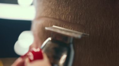 Barbershop: woman hairdresser cuts man's hair with razor