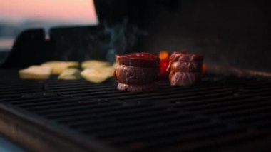 BBQ close-up: filet mignon steak and grilled vegetables cooking
