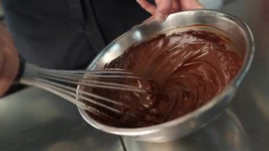 Close-up of chocolate being kneaded in brownie bowl