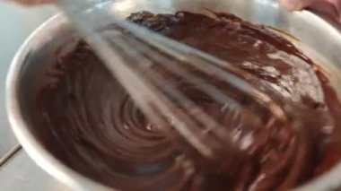 Close-up of chocolate being kneaded in brownie bowl