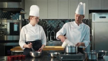 Milk is churned in a professional restaurant kitchen. Dessert cooking.