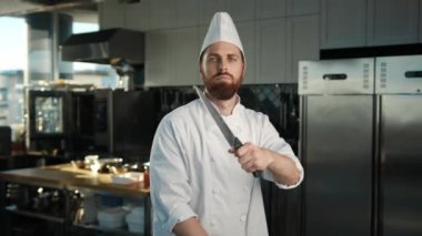 Professional kitchen portrait: Chef brandishing knives like ninja