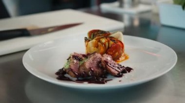 Filet mignon and ratatouille on a plate serving a dish in restaurant