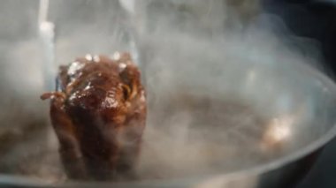 Close-up of a filet mignon being cooked in frying pan