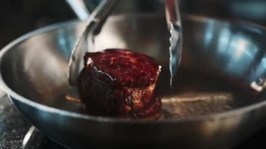 Close-up of a filet mignon being cooked in frying pan