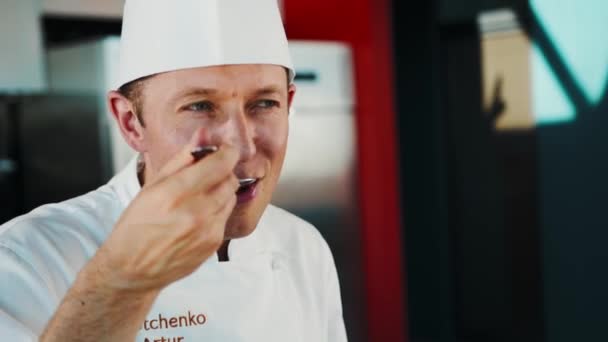 Close Chef Tries Sauce Spoon Enjoys Taste — Stockvideo