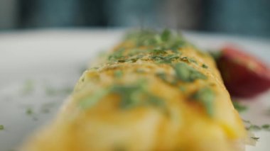 Close-up: French omelette with herbs in professional kitchen