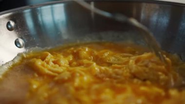 Professional restaurant kitchen, close-up: the process of cooking an omelette in frying pan