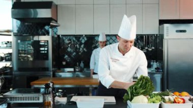 Professional restaurant kitchen, portrait of chefs Men and women: Chef's assistant brings the ingredients