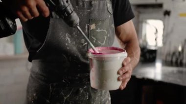 Close-up: paint is depicted with solvent in the workshop of an artist - sculptor
