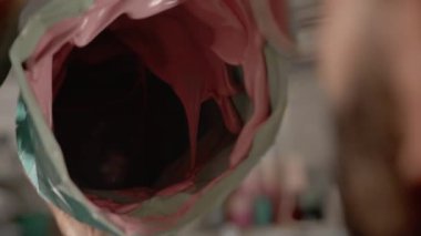 A male creator, sculptor, handyman creates handmade art object.