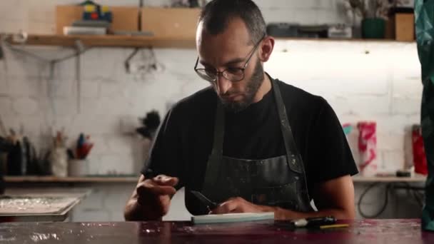 Man Arab Appearance Sharpens Blade Workshop Sculptor Painter Needleworker — Stockvideo