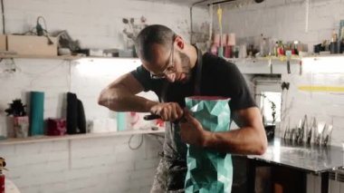 A male craftsman creates decorative product with his own hands. Handmade, workshop. Creative chaos.
