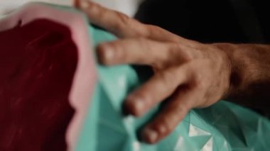 Close-up: pattern vase in the hands of sculptor artisan artist in the workshop