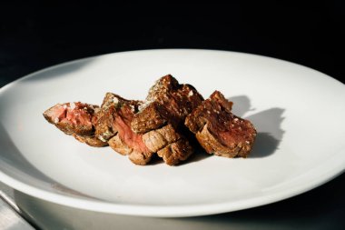 Professional restaurant kitchen, close up: sliced delicious juicy filet mignon steak