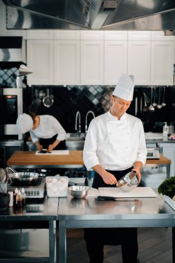 Professional restaurant kitchen: chefs prepare delicious dish