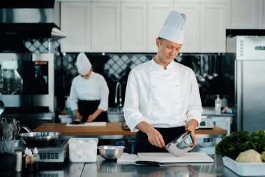 Professional restaurant kitchen: chefs prepare delicious dish