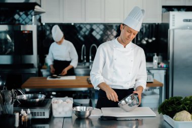 Professional restaurant kitchen: chefs prepare delicious dish