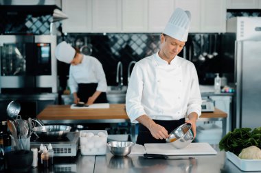 Professional restaurant kitchen: chefs prepare delicious dish