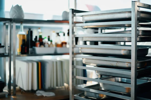 Interior professional restaurant kitchen, the rack with baking sheets