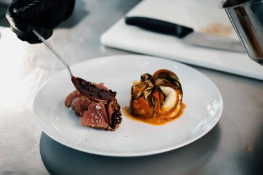 Filet mignon and ratatouille served on a plate in professional restaurant
