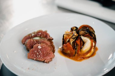Filet mignon and ratatouille served on a plate in professional restaurant