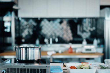 The interior of a professional kitchen in restaurant. Food items are ready to be cooked.