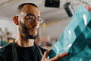 Close-up: artisan sculptor artist creates handmade vase in his workshop
