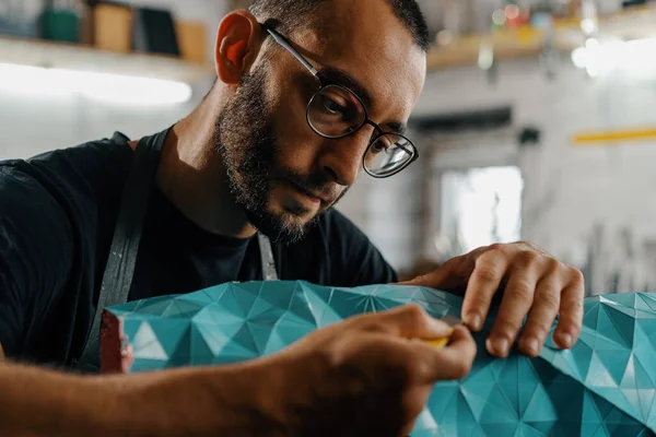 Close-up: artisan sculptor artist creates handmade vase in his workshop