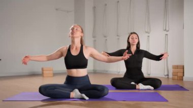 Woman learn yoga pilates with coach trainer. Girl using mat exercise, follow fitness instructor workout for health