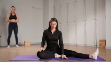 Girl in sportswear is preparing for yoga class.