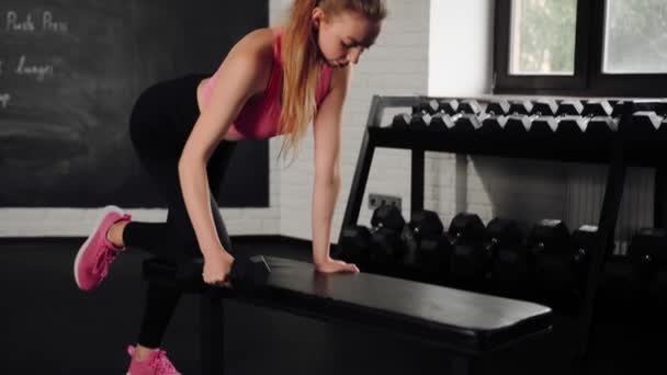 Athletic Girl Athlete Trains Her Back Dumbbells Gym Dumbbell Bench — Video Stock
