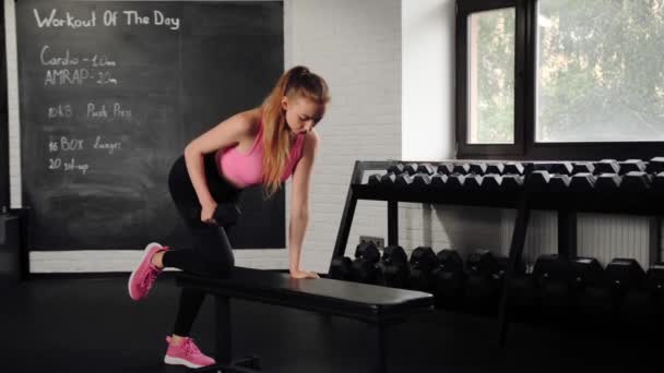 Athletic Girl Athlete Trains Her Back Dumbbells Gym Dumbbell Bench — Stockvideo