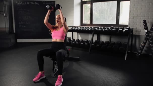 Girl Does Exercise Gym Female Athletic Woman Exercising Shoulders Dumbbells — Stockvideo