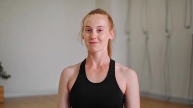 Athletic woman doing yoga for health. The girl is in the lotus position and folds her hands Namaste