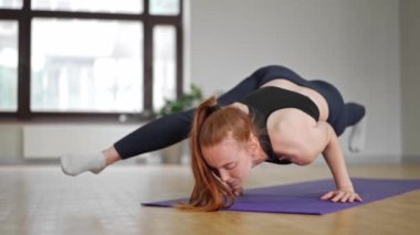 Athletic woman doing yoga for health. The girl is in the lotus position and folds her hands Namaste