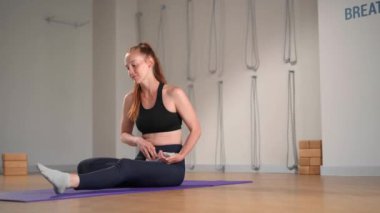 Fitness coach teaching yoga online to group of people. People practicing yoga with trainer with video conference.