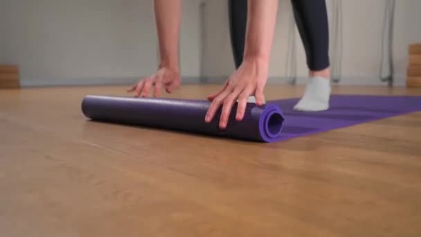 Woman Rolling Yoga Mat Training Studio Girl Folding Fitness Mat — Wideo stockowe
