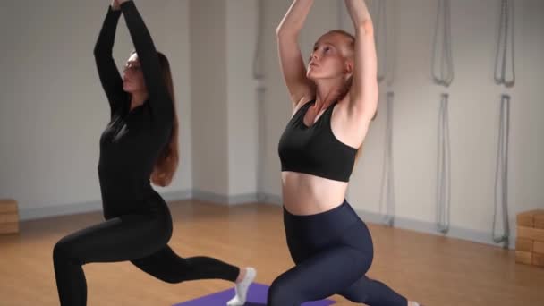 Two Athletic Women Doing Yoga Sports Studio Workout Stretching Health — 图库视频影像