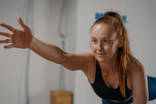 Athletic woman doing pilates yoga stretching for health in the studio. Athletic body girl.