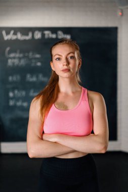Athletic woman posing and showing her shape in t gym