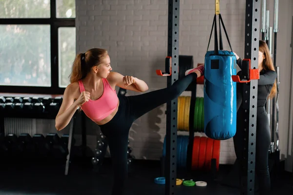 Athletic Woman Engaged Training Kick Punching Bag Her Girlfriend Gym — 스톡 사진