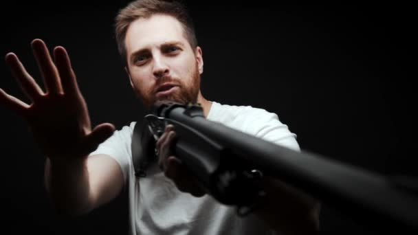 Close Man Holds Shotgun His Hands Aims Looks Camera — Vídeo de Stock