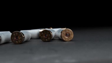 Close-up: shotgun cartridges on a table against dark background