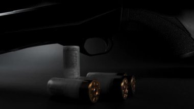 Close-up: light glides over a hunting shotgun with cartridges on a table against dark background