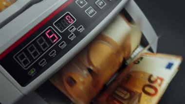 Money counting equipment for paper money calculation Automatic mechanism for bank financial operations. Close up of euro banknotes while being counted