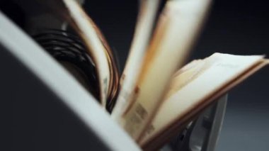 Money counting equipment for paper money calculation Automatic mechanism for bank financial operations. Close up of euro banknotes while being counted